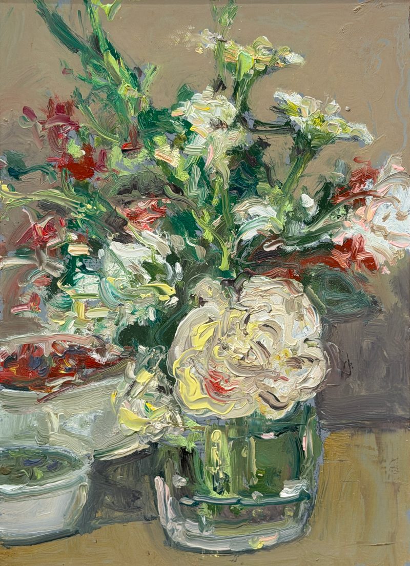 White roses and red flowers in a glass jar beside bowls