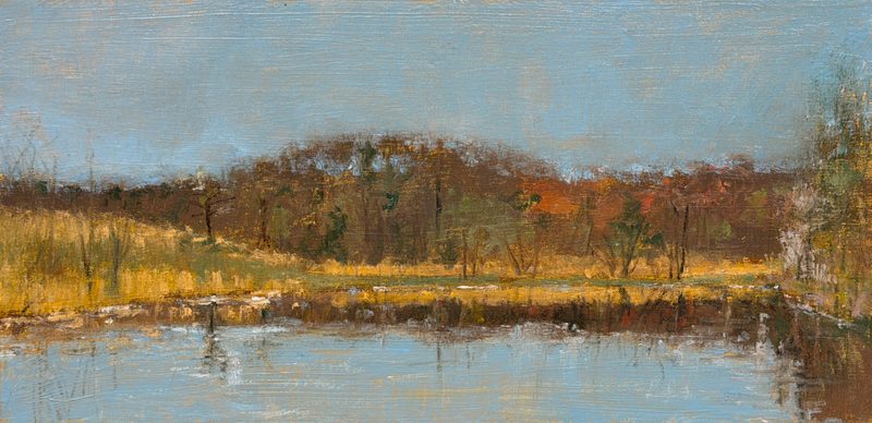 Pond below autumn woods